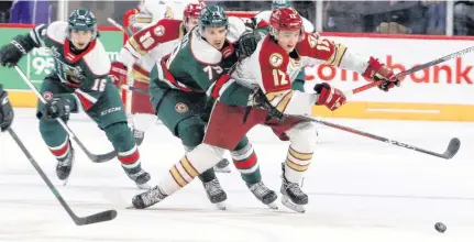  ?? ERIC WYNNE CHRONICLE HERALD       ?? With Halifax Mooseheads James Swan, left, and Jason Horvath in chase, Bathurst Titan’s Riley Kidney races to get control of the puck around centre ice during a Nov. 20 QMJHL game against the Bathurst Titan at the Scotiabank Centre.