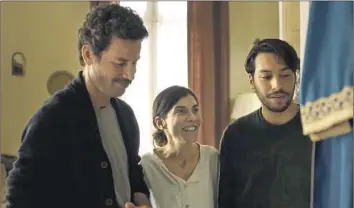  ?? Strand Releasing ?? MINA (Lubna Azabal) is flanked by Halim (Saleh Bakri, left) and Youssef (Ayoub Missioui) in “Blue Caftan.”