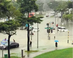  ??  ?? A road in Bedok that was inundated yesterday.