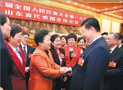  ?? YAO DAWEI / XINHUA ?? President Xi Jinping, who is also general secretary of the Communist Party of China Central Committee, speaks with deputies to the National People’s Congress from Shandong province at a panel discussion on Thursday in Beijing.