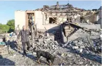  ?? — Reuters file photo ?? CONFLICT: A man removes debris in front of his house, which was damaged by a recent shelling, in the government-held town of Avdiyivka, Ukraine, May 23, 2017.