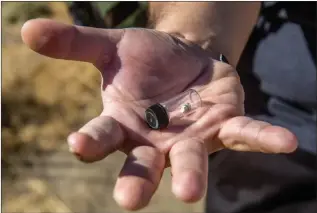  ?? Austin Dave/The Signal (See additional photos at signalscv.com) ?? Santa Clarita resident Sgt. Jon Morita, a veteran of the Iraq and Afghanista­n wars, holds a container with shrapnel that was removed from his elbow.