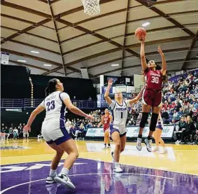  ?? Troy Wayrynen/Associated Press ?? Stanford’s Haley Jones, who scored 17 points, rises above Portland guard McKelle Meek (1) to launch a shot during the Cardinal’s victory.