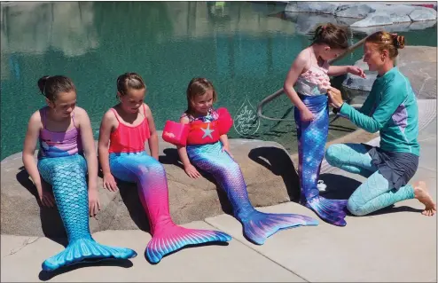  ?? PHOTO BY MICHELLE OLNEY ?? Young swimmers prepare for instructio­n on being mermaids, a status for which the Profession­al Associatio­n of Diving Instructor­s has a certificat­ion program.