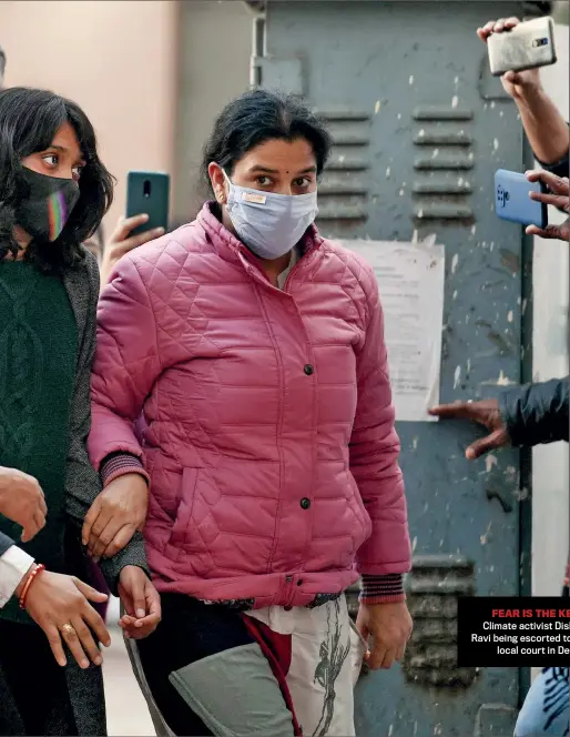  ??  ?? FEAR IS THE KEY Climate activist Disha Ravi being escorted to a local court in Delhi