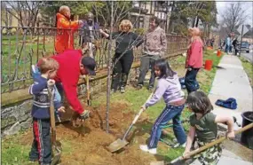  ??  ?? Tree planting can be a multi-generation­al experience that teaches kids the role trees play in their environmen­t.