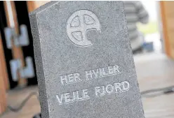  ?? —PHOTOS BY AFP ?? TROUBLED DEMISE Activists erect a tombstone with the inscriptio­n “Here rests Vejle Fjord”.