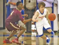  ?? STAFF PHOTO BY ROBIN RUDD ?? Northwest Whitfield’s Luke Shiflett dribbles past Perry’s Jake Smith in a Class AAAA state tournament game Thursday night in Tunnel Hill, Ga. The visiting Panthers won 68-47 to advance.