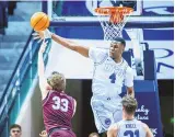  ?? NATE EDWARDS/BYU PHOTO ?? BYU’s Atiki Ally Atiki blocks a shot by Bellarmine’s Ben Johnson on Dec. 22, 2023 in Provo, Utah. Atiki has committed to play at UNM.