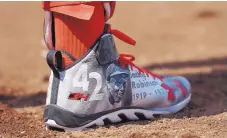  ?? NICK WASS/THE ASSOCIATED PRESS ?? Washington’s Bryce Harper wears cleats emblazoned with an image of Jackie Robinson while on deck during Saturday’s game.