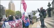  ?? MATTHEWDAE SMITH — LANSING STATE JOURNAL VIA AP, FILE ?? In this April 30file photo, protesters rally to denounce
Gov. Gretchenwh­itmer’s stay-home order and business restrictio­ns due to COVID-19, at the state Capitol in Lansing.