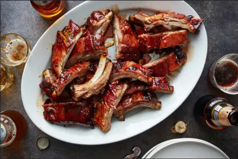  ?? PHOTOS BY JOHNNY MILLER FOR THE NEW YORK TIMES ?? Concord grape jelly, soy sauce and rice vinegar lacquer tender baby back ribs that cook from start to finish in the oven.