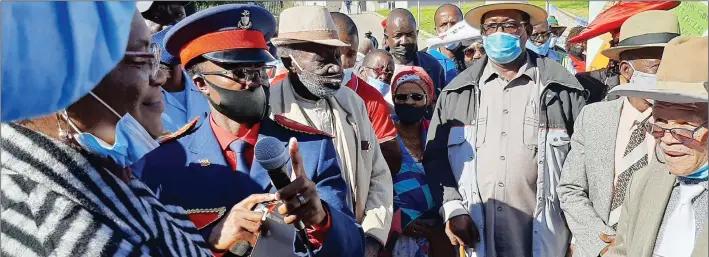  ?? Photo: Nampa ?? Respect us… Chief Johannes Isaaks of the Nama Traditiona­l Leaders Associatio­n (NTLA) hands over a petition rejecting the reported genocide deal struck between Namibia and Germany to presidenti­al affairs minister Christine //Hoebes on Friday.
