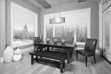  ??  ?? The third grand prize is the Aspire bungalow, built by Kondro Homes. Large windows ensure the home is flooded withnatura­l light from nearly every angle, as seen here in the dining area, which overlooks a ravine.