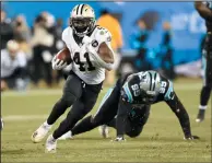  ?? AP PHOTO/MIKE MCCARN ?? New Orleans Saints' Alvin Kamara (41) runs past Carolina Panthers' Kawann Short (99) in the second half of an NFL game in Charlotte, N.C., Monday.