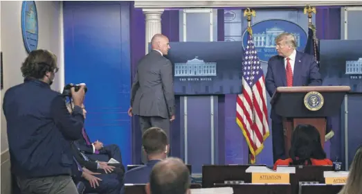  ?? BRENDAN SMIALOWSKI/AFP VIA GETTY IMAGES ?? President Donald Trump is being escorted from the Brady Briefing Room of the White House by a member of the Secret Service.