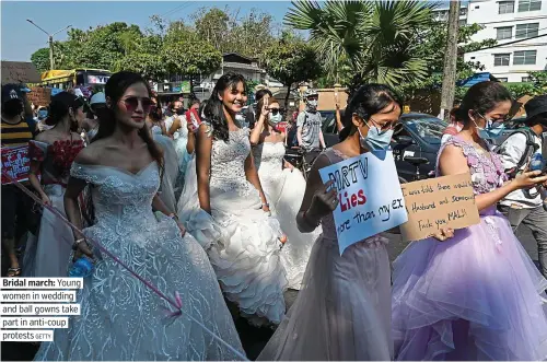  ??  ?? Bridal march: Young women in wedding and ball gowns take part in anti-coup protests