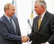  ?? Mikhail Klimentyev / RIA-Novosti file via Associated Press ?? Russian President Vladimir Putin and Rex Tillerson, then Exxon Mobil’s CEO, at a ceremony in 2012.