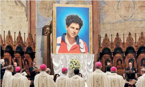  ?? (AFP) ?? Image of 15-year-old Carlo Acutis, who died in 2006 of leukemia, is unveiled during his beatificat­ion ceremony celebrated by Cardinal Agostino Vallini in the St. Francis Basilica in Italy