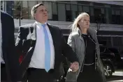  ?? CHARLES KRUPA — THE ASSOCIATED PRESS FILE ?? John Wilson, left, arrives at federal court with his wife Leslie to face charges in a nationwide college admissions bribery scandal in Boston.