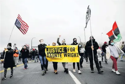  ?? PHOTO: REUTERS ?? Outrage . . . Protesters march up 65th Ave North from the Brooklyn Center Police Department to the FBI Minneapoli­s Division building in Brooklyn Center, Minnesota, United States, yesterday, days after Daunte Wright (20) was shot and killed by former Brooklyn Center police officer Kim Potter.