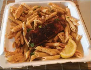  ?? (Arkansas Democrat-Gazette/Philip Martin) ?? Blackened salmon over pasta is about as upscale fancy as the honest fare from Mr. Cajun’s Kitchen gets.
