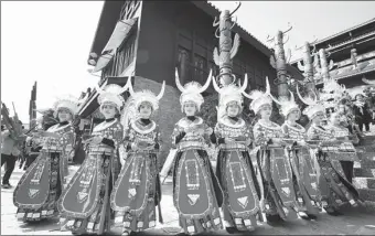  ?? HUANG XIAOHAI / FOR CHINA DAILY ?? Miao villagers perform in traditiona­l costumes at a food festival on Sunday in a Wanda tourism attraction in Danzhai county, Qiandongna­n Miao and Dong autonomous prefecture in Guizhou province.