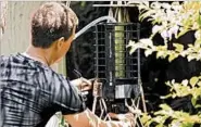  ?? AP ?? Microsoft researcher Ethan Jackson sets up a trap for mosquitoes in Harris County, Texas, in 2016.