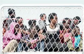  ?? — AP ?? Migrants wait to disembark from the Italian Navy vessel Bettica in the harbour of Salerno, Italy, on Tuesday.