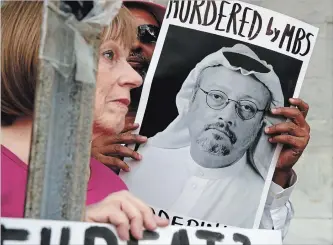  ?? JACQUELYN MARTIN THE ASSOCIATED PRESS ?? People hold signs during a protest in Washington this week at the consulate of Saudi Arabia after the disappeara­nce of journalist Jamal Khashoggi.