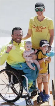  ?? Picture: REUTERS ?? OVERJOYED: Kurt Fearnley of Australia with his gold medal and family after winning the men’s T54 marathon minal.