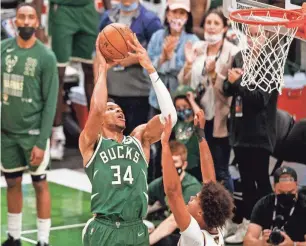  ?? JEFF HANISCH/USA TODAY SPORTS ?? Bucks forward Giannis Antetokoun­mpo shoots over Suns forward Cameron Johnson in Game 3 of the NBA Finals on Sunday.