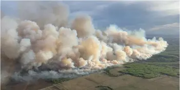  ?? — AFP photo ?? This aerial handout picture courtesy of the Alberta Wildfire Service shows smoke from wildfires burning in the Grande prairie forest area, 4 km east of the town of Teepee Creek, in Alberta, Canada.