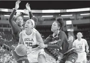  ?? Ted S. Warren Associated Press ?? UCLA’S Monique Billings drives between California’s CJ West, left, and Kianna Smith during the Bruins’ win.