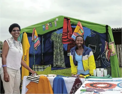  ?? Picture: MARK CARRELS ?? DRESSED FOR SUCCESS: Thotho Mbatsha, left, and Awonke Mpande at Mbatsha’s stall showcasing her colourful handmade Xhosa outfits at the Bathurst Agricultur­al Show.