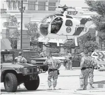  ??  ?? Holding the fort: The National Guard on patrol in Ferguson this week after rioting and looting injured 100 and led to 500 arrests.