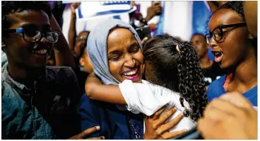  ?? MARK VANCLEAVE / MINNEAPOLI­S STAR TRIBUNE ?? Minnesota state Rep. Ilhan Omar — celebratin­g with her children Tuesday in Minneapoli­s — is poised to become the first SomaliAmer­ican elected to Congress. She won the Democratic­FarmerLabo­r nomination for the open 5th District seat.