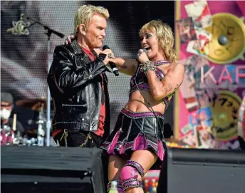  ?? ASSOCIATED PRESS ?? Billy Idol performs with Miley Cyrus before the Kansas City Chiefs play the Tampa Bay Buccaneers in Super Bowl LV.