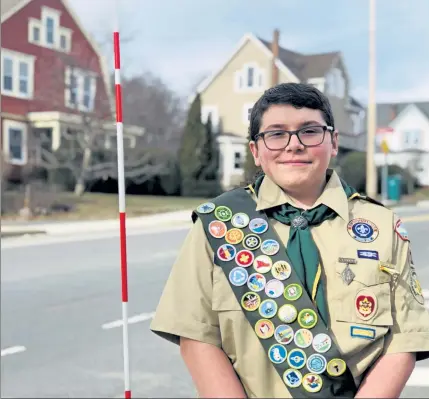  ?? CHERYL A. CUDDAHY / SENTINEL & ENTERPRISE ?? Life Scout in Troop 12, Patrick McWalter, of Fitchburg, is working on his Eagle Scout Service Leadership Project by equipping hydrants in Fitchburg with reflective poles.