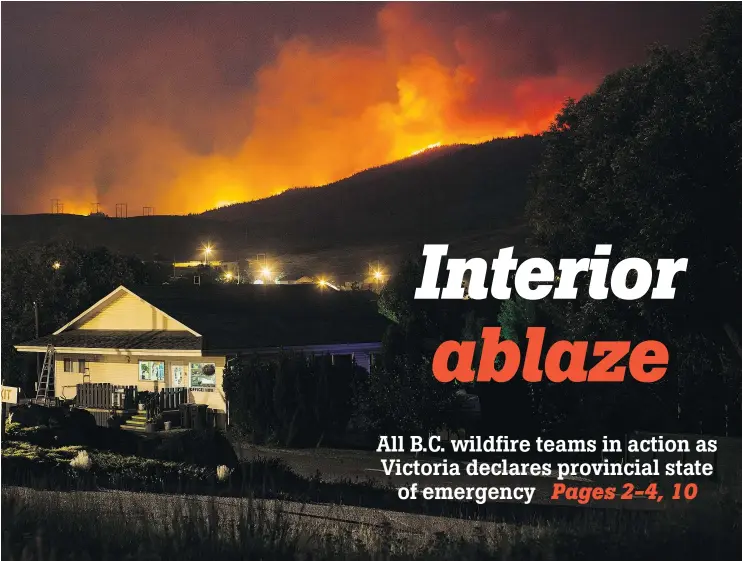  ?? — THE CANADIAN PRESS ?? A wildfire burns on a mountain behind an RV park office in Cache Creek in the early morning hours of Saturday. More than 3,000 residents have been evacuated from their homes in central B.C. A provincial state of emergency was declared after 173 new...