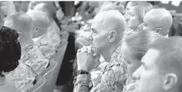  ?? MARTIN H. SIMON/GETTY ?? Military personnel listen to the president Thursday at the Pentagon, in Arlington, Va.