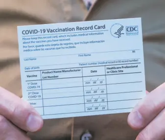  ?? Nick Otto / Special to The Chronicle 2020 ?? Dr. Stephen Hall, director of psychiatry at the San Francisco Campus for Jewish Living, holds an allimporta­nt vaccinatio­n card after receiving the coronaviru­s vaccine in December.