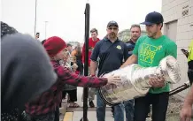  ??  ?? The Washington Capitals’ Chandler Stephenson shares the Stanley Cup his team won earlier this year with fans gathered outside Elgar Petersen Arena during Humboldt Hockey Day on Friday.