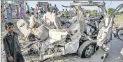  ?? AFP ?? Residents gather around the wreckage of a van alongside a railway track in Sheikhupur­a district of Pakistan's Punjab on Friday.