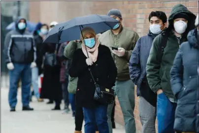  ?? The Associated Press ?? MINIMUM LEVELS: People line up on April 23 at Gotham Health East New York, a COVID-19 testing center in the Brooklyn borough of New York. An Associated Press analysis finds that most states are not meeting the minimum levels of testing suggested by the federal government and recommende­d by public health researcher­s even as many of them begin to reopen their shattered economies.