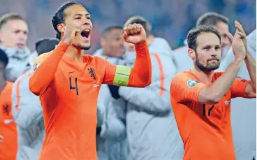  ?? (AFP) ?? Netherland­s' Virgil van Dijk (left) and Daley Blind celebrate their qualificat­ion into the Euro 2020 finals in Belfast, Northern Ireland, on Saturday