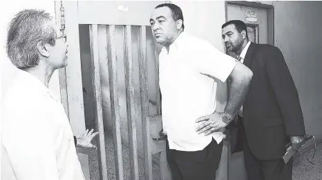  ?? FILE ?? Health Minister Christophe­r Tufton listens keenly to Dr Myo Kyaw Oo (left) while Dr Winston De La Haye, chief medical officer, looks on during a tour of a section of the Bellevue Hospital last December. Tufton has been praised by Martin Henry for the...