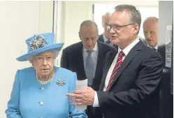  ?? Picture: Gordon Robbie. ?? Tayside director of the year John Reid escorts the Queen on a tour of Michelin’s Dundee factory last year.