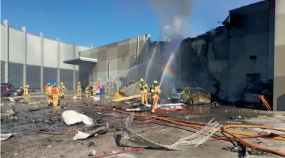  ?? AFP ?? Firemen putting out a blaze from a light aircraft which exploded as it smashed into a shopping centre near Melbourne on Tuesday. —