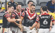  ??  ?? Roosters’ winger Matt Ikuvalu celebratin­g one of his five tries.